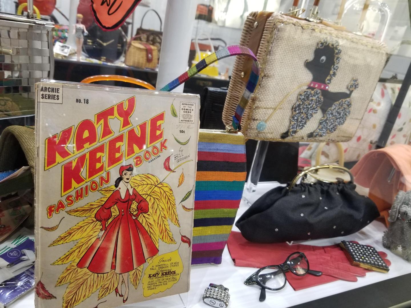 Vintage comic book display with bags, glasses, and colorful items.