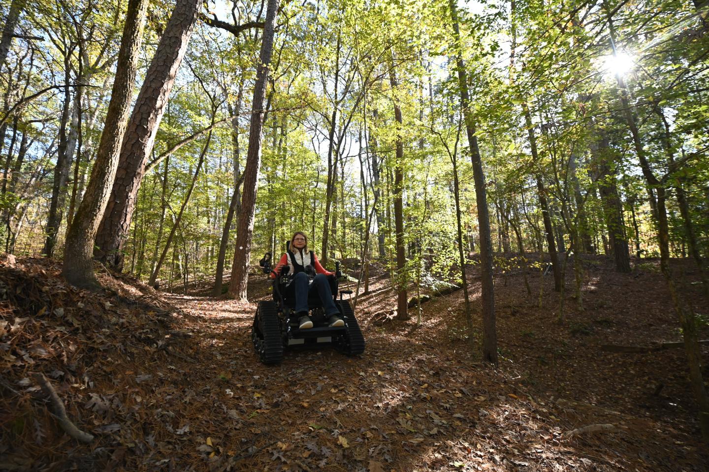 Young woman using a track chair at Pinnacle Mountain State Park.