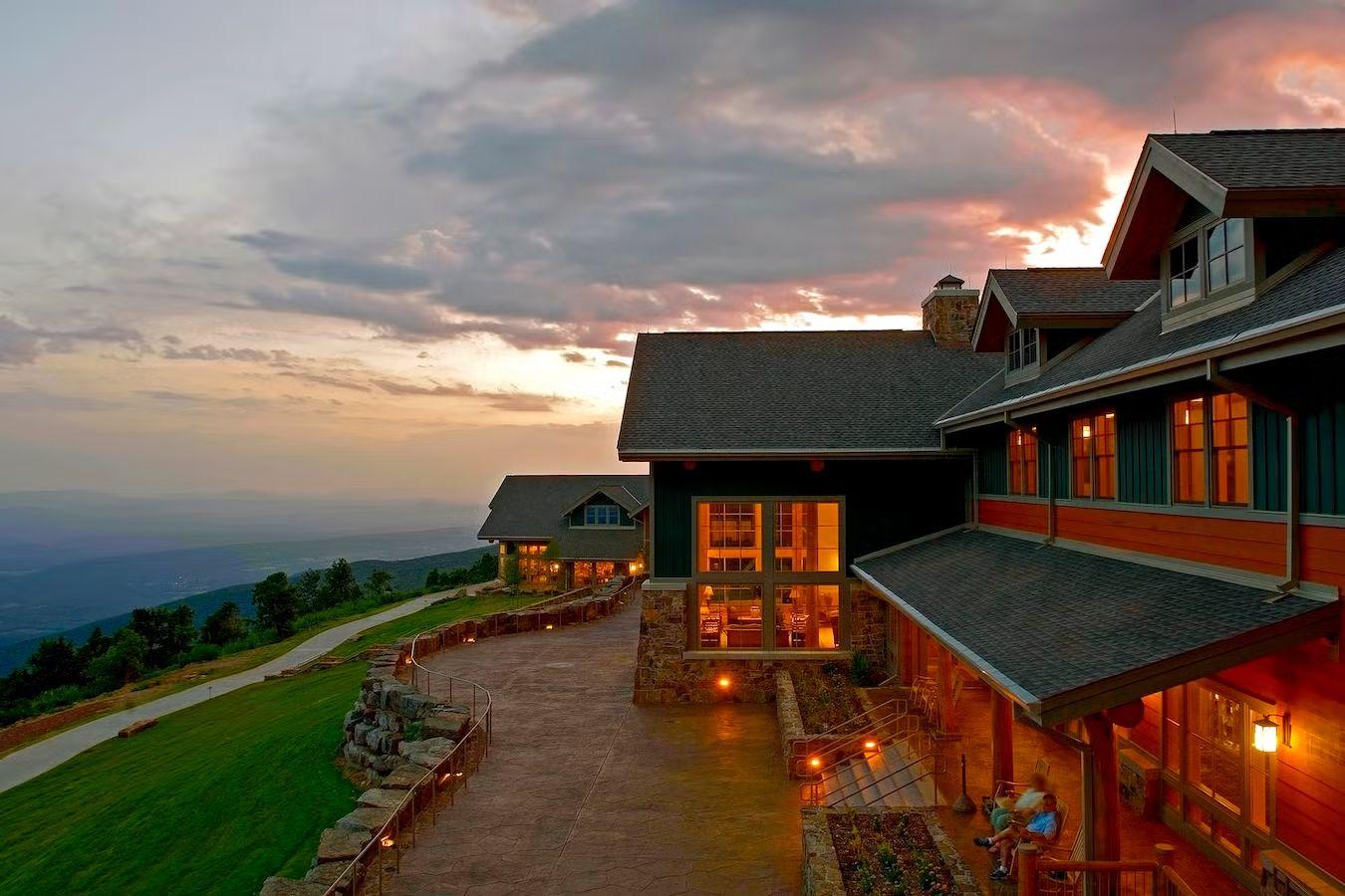 Lodge at sunset with dramatic sky and mountain view.