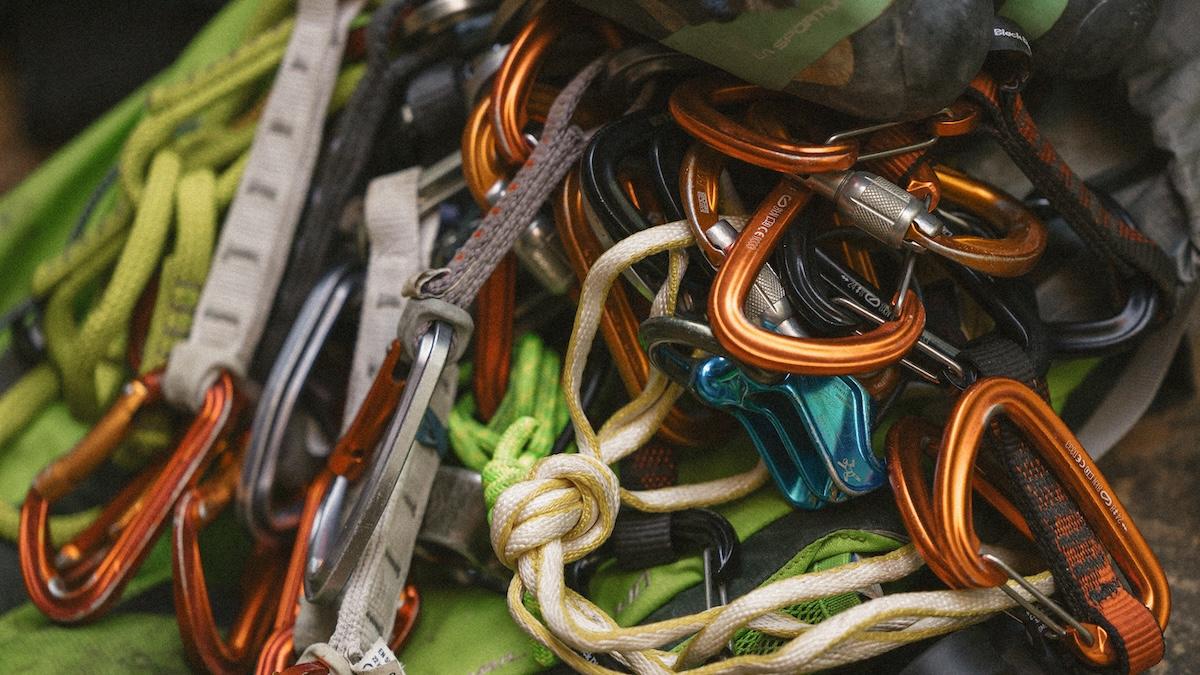 Climbing gear with carabiners and ropes in various colors.