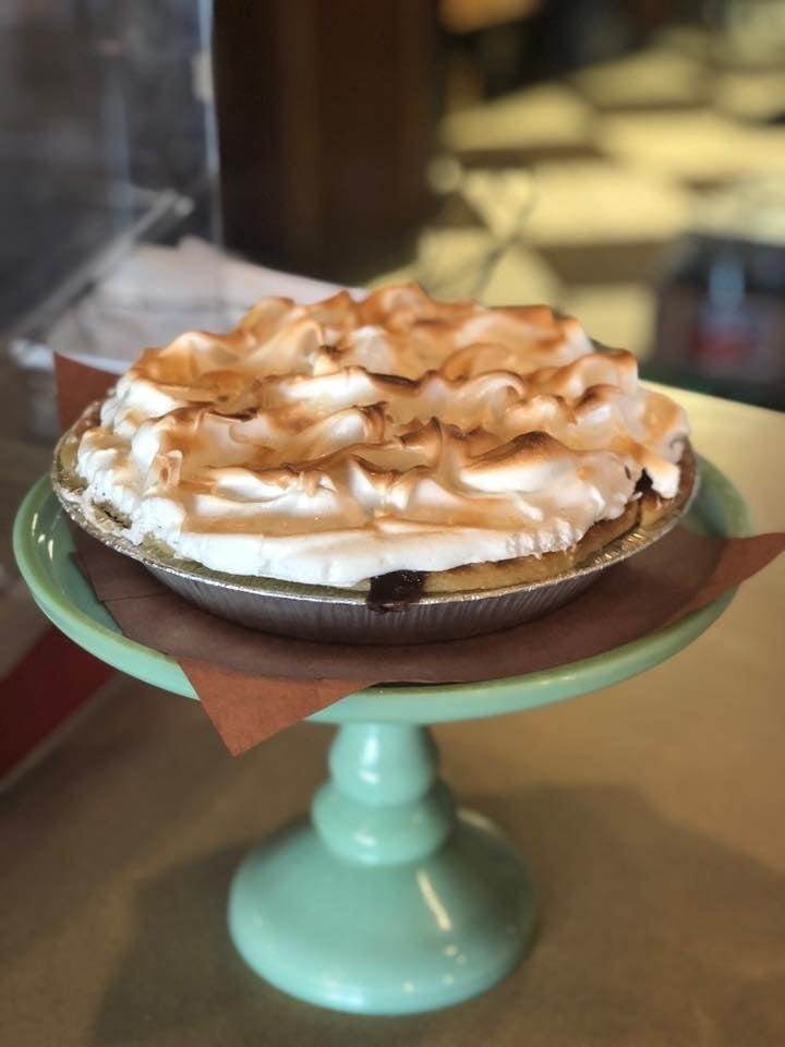 Cream pie on a turquoise cake stand.